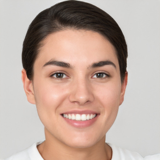 Joyful white young-adult female with short  brown hair and brown eyes