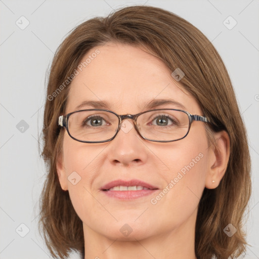 Joyful white adult female with medium  brown hair and grey eyes