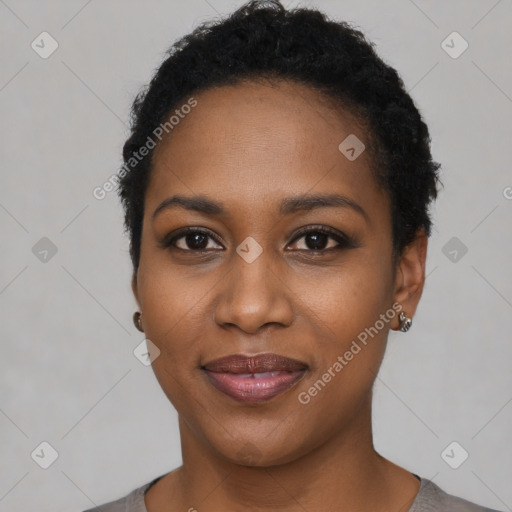 Joyful black young-adult female with short  black hair and brown eyes