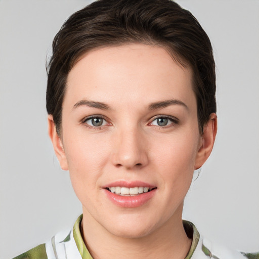 Joyful white young-adult female with medium  brown hair and grey eyes