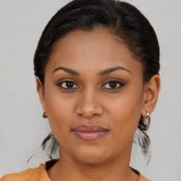 Joyful black young-adult female with short  brown hair and brown eyes