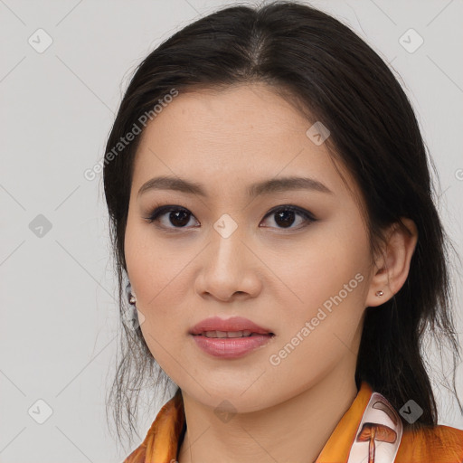 Joyful asian young-adult female with long  brown hair and brown eyes