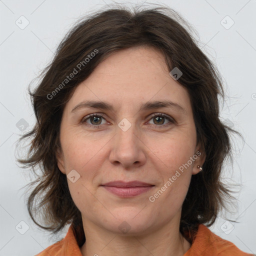 Joyful white adult female with medium  brown hair and brown eyes