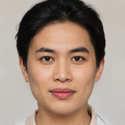 Joyful asian young-adult male with short  brown hair and brown eyes
