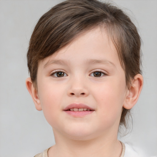 Joyful white child female with short  brown hair and brown eyes