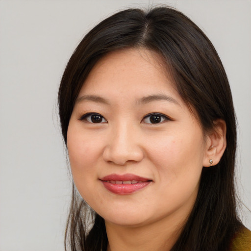Joyful asian young-adult female with long  brown hair and brown eyes