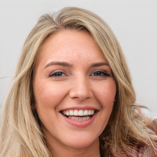 Joyful white young-adult female with long  brown hair and green eyes