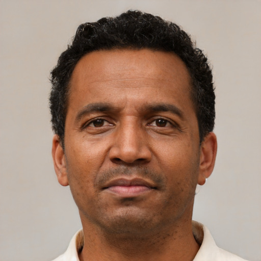 Neutral latino adult male with short  black hair and brown eyes