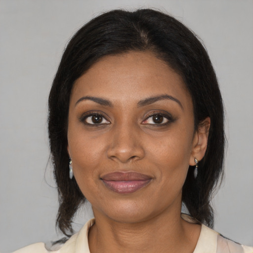 Joyful black young-adult female with medium  brown hair and brown eyes