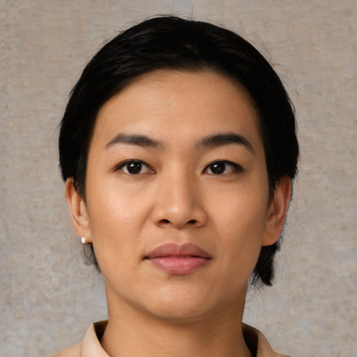Joyful asian young-adult female with short  black hair and brown eyes