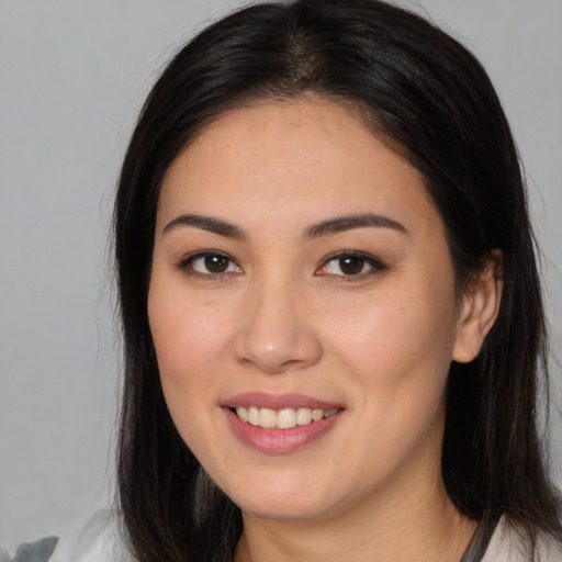 Joyful white young-adult female with long  brown hair and brown eyes