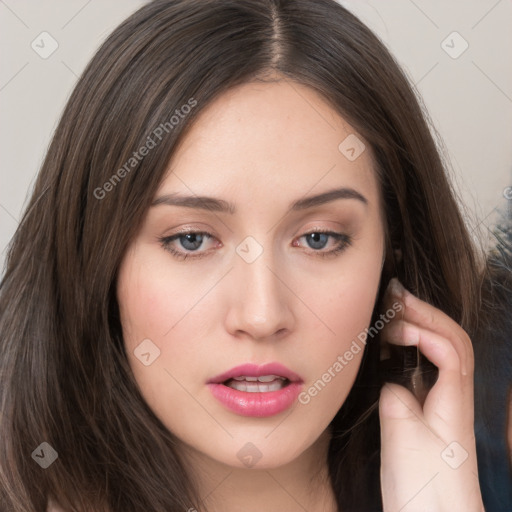 Neutral white young-adult female with long  brown hair and brown eyes