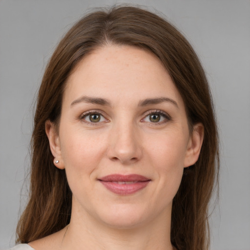 Joyful white young-adult female with medium  brown hair and grey eyes