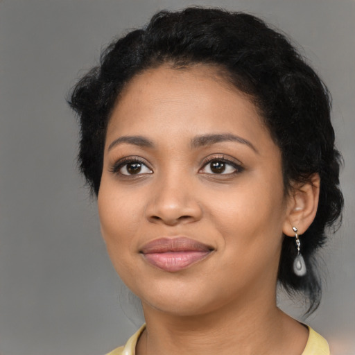 Joyful latino young-adult female with medium  black hair and brown eyes