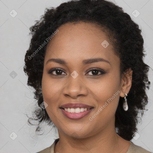 Joyful black young-adult female with long  black hair and brown eyes