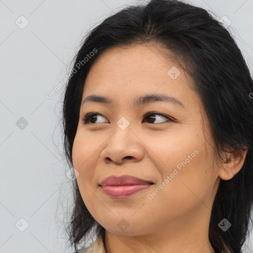 Joyful asian young-adult female with long  brown hair and brown eyes