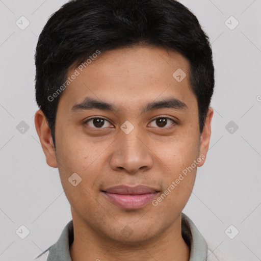 Joyful latino young-adult male with short  brown hair and brown eyes