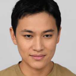 Joyful asian young-adult male with short  black hair and brown eyes