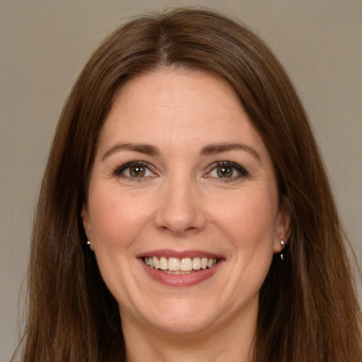 Joyful white adult female with long  brown hair and brown eyes