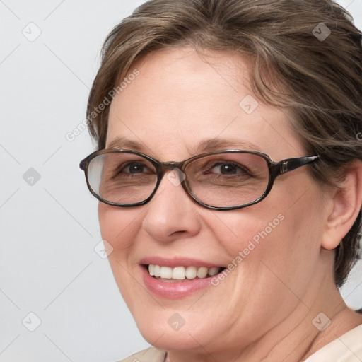 Joyful white adult female with medium  brown hair and blue eyes