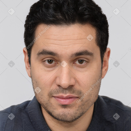 Joyful white adult male with short  black hair and brown eyes