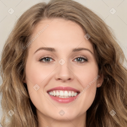 Joyful white young-adult female with long  brown hair and green eyes