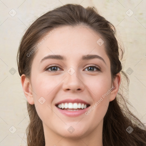 Joyful white young-adult female with long  brown hair and green eyes