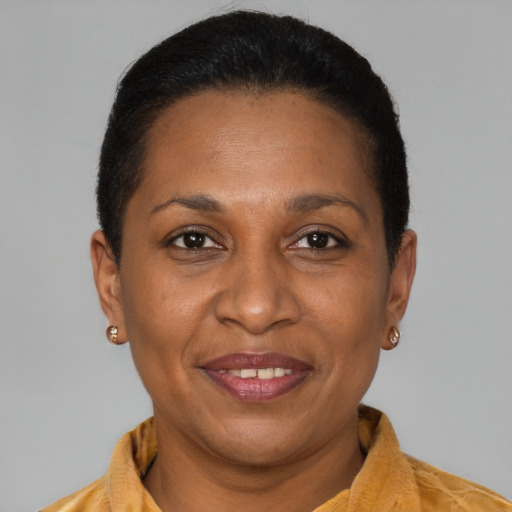 Joyful latino adult female with short  brown hair and brown eyes