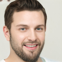 Joyful white young-adult male with short  brown hair and grey eyes