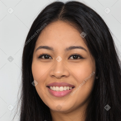 Joyful latino young-adult female with long  black hair and brown eyes