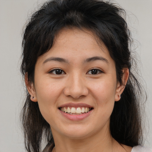 Joyful white young-adult female with medium  brown hair and brown eyes