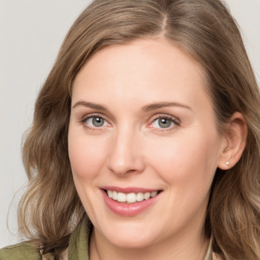 Joyful white young-adult female with medium  brown hair and green eyes