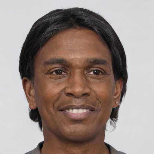 Joyful black adult male with short  black hair and brown eyes