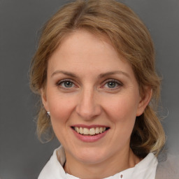 Joyful white adult female with medium  brown hair and grey eyes