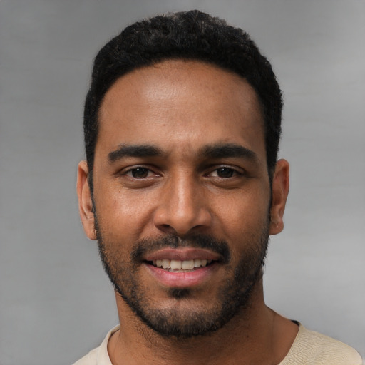 Joyful white young-adult male with short  black hair and brown eyes