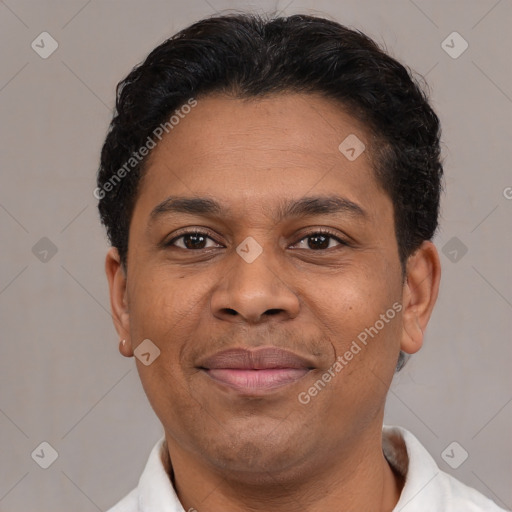 Joyful latino adult male with short  brown hair and brown eyes