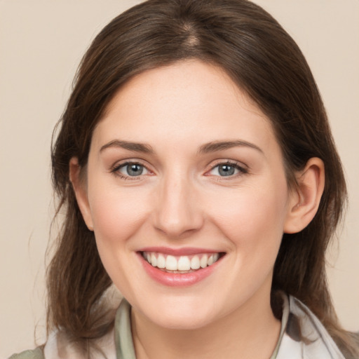 Joyful white young-adult female with medium  brown hair and brown eyes