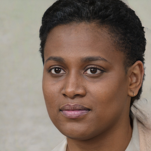 Joyful black young-adult female with short  brown hair and brown eyes