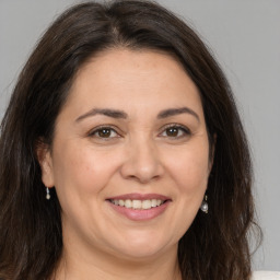 Joyful white adult female with medium  brown hair and brown eyes