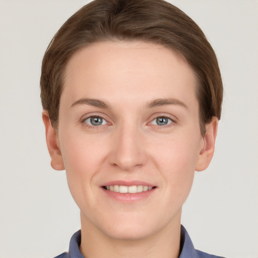 Joyful white young-adult female with short  brown hair and grey eyes