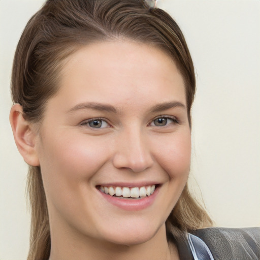 Joyful white young-adult female with long  brown hair and grey eyes