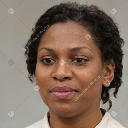 Joyful black adult female with short  brown hair and brown eyes