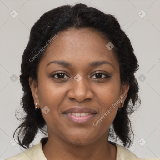 Joyful black young-adult female with long  brown hair and brown eyes