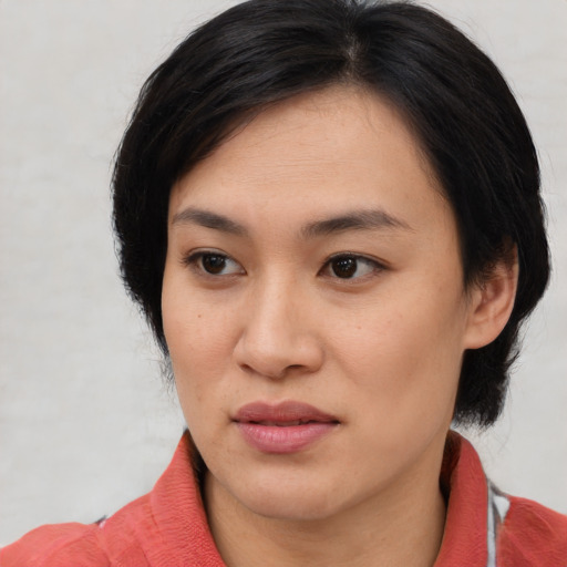 Joyful white young-adult female with medium  black hair and brown eyes
