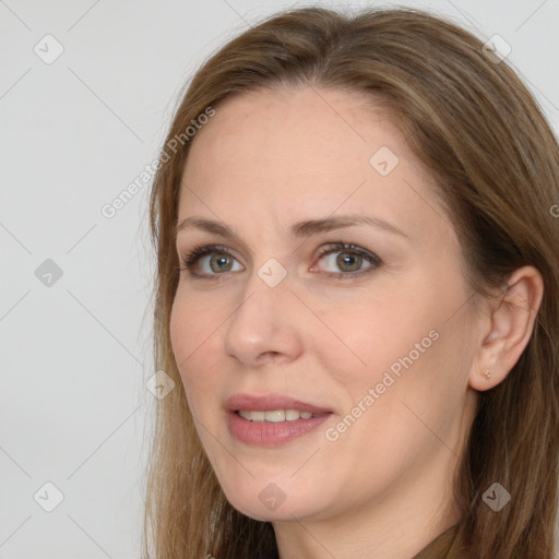 Joyful white adult female with long  brown hair and grey eyes