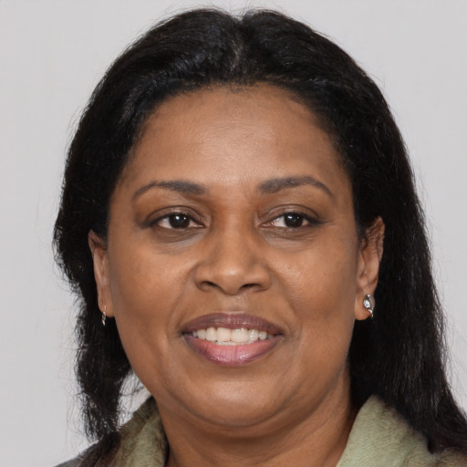 Joyful black adult female with medium  brown hair and brown eyes