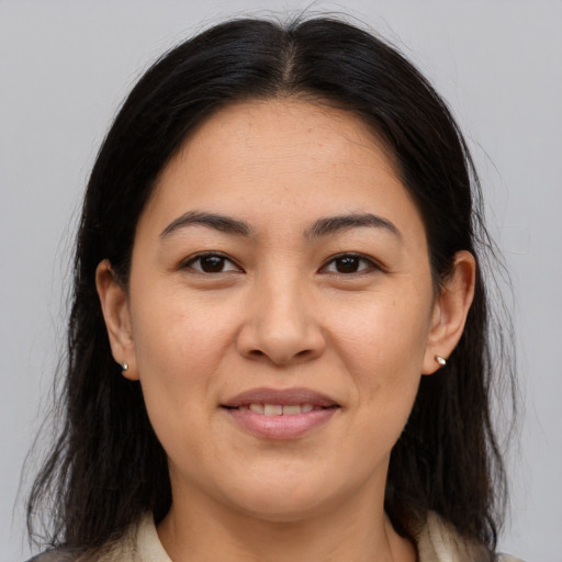 Joyful asian adult female with medium  brown hair and brown eyes