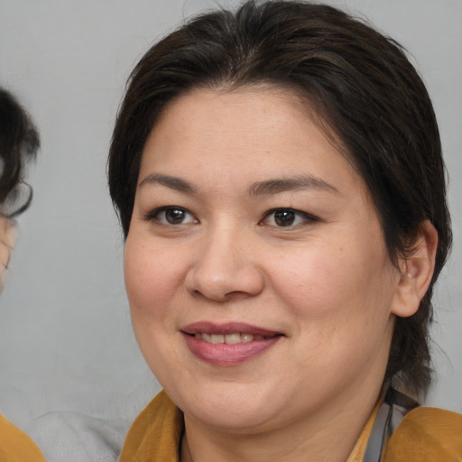 Joyful white adult female with medium  brown hair and brown eyes
