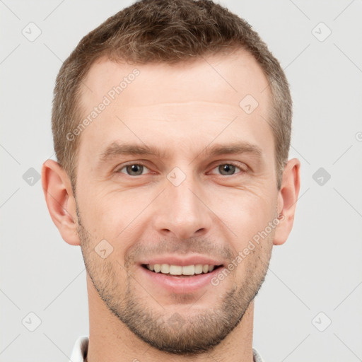 Joyful white young-adult male with short  brown hair and grey eyes