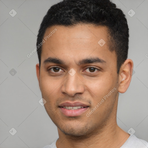 Joyful white young-adult male with short  black hair and brown eyes